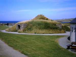 Modern mock up of a Skara Brae house with tunnel access passageways and turf covered roof (much like the rooves of traditional Skandanavian houses).