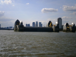 One of the Thames Barrier spans closed. The Barrier is the world's second largest moveable flood barrier (the largest is in Holland). It is located at New Charlton, where the chalk layer under the Thames is strong enough to support the structure. The concept of the rotating gates was devised by (Reginald) Charles Draper. In the 1950s, from his parents' house in Pellatt Grove, Wood Green, London, he constructed a working model. The Barrier only really became possible once all major shipping moved eastwards so that large ships no longer had to travel intothe Port of London to be discharged and loaded