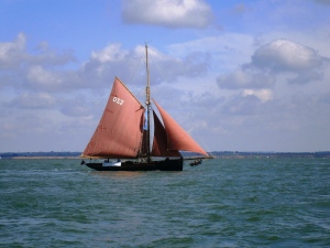 A gaff rigger sailing by Cowes in the sunshine